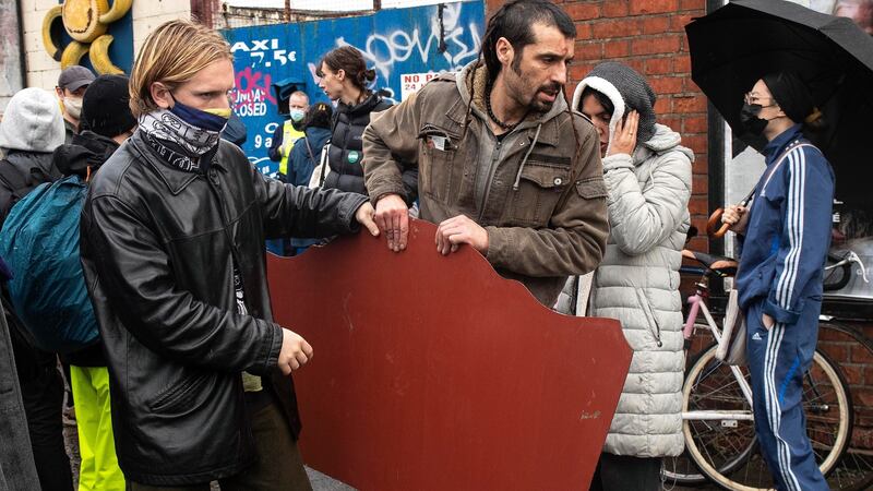 Fernando Estelles, aged 43, right, who was evicted from a site on Prussia Street in Dublin City centre is helped to remove his belongings. Photograph: Damien Eagers