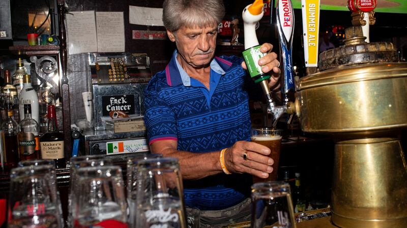 Tom McGrath, owner of the Black Sheep pub, pulls a pint for a customer in New York. Photograph: Monique Jaques/The New York Times