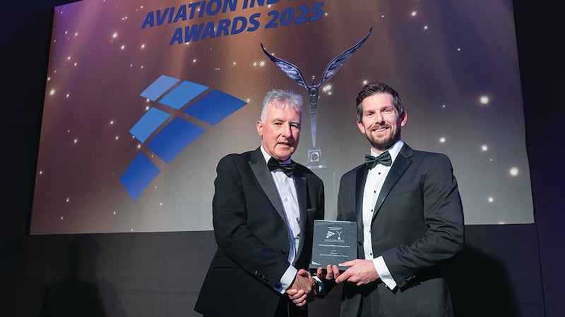 Michael Treacy, awards judge, presents the best emerging aviation technology award to Justin Perry, Frequency