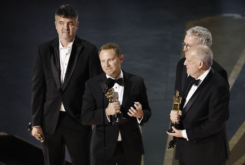 Richard Baneham,  (centre) with Eric Saindon, Daniel Barrett and Joe Letteri after winning the best visual effects Oscar for Avatar: The Way of Water in 2023. Photograph: Etienne Laurent/EPA