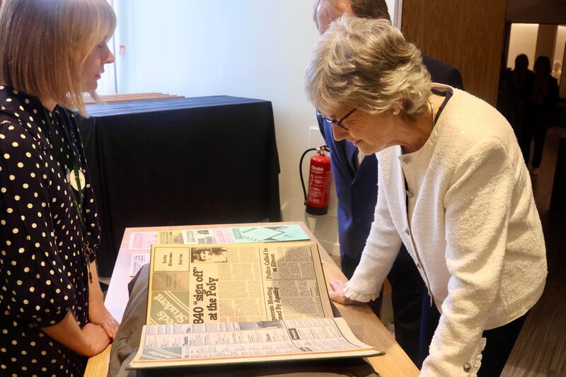 President Catherine Connolly views a copy of a student newspaper from her time at the University of Leeds in 1981-1982