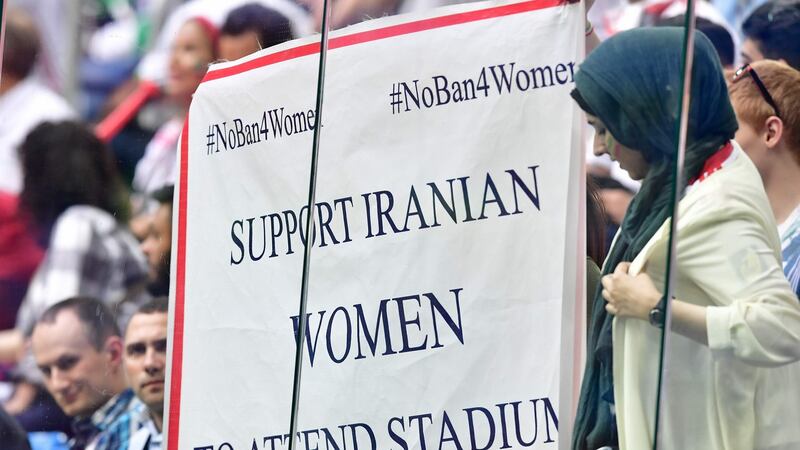 Woman hold a protest sign during the Morocco-Iran match at last year’s World Cup in Russia. Photograph:  Giuseppe Cacace/AFP/Getty Images