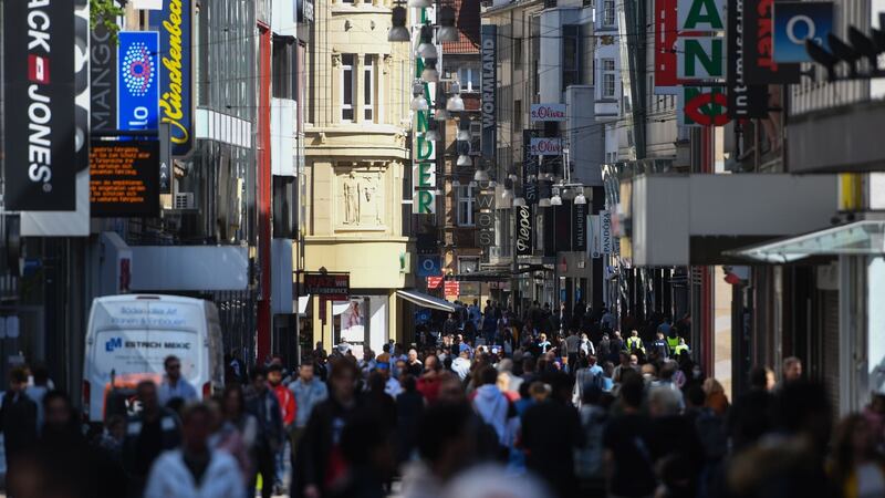 People walk past shops on a pedestrian street in Dortmund,  western Germany, on Monday. Photograph: Ina Fassbender/AFP via Getty Images