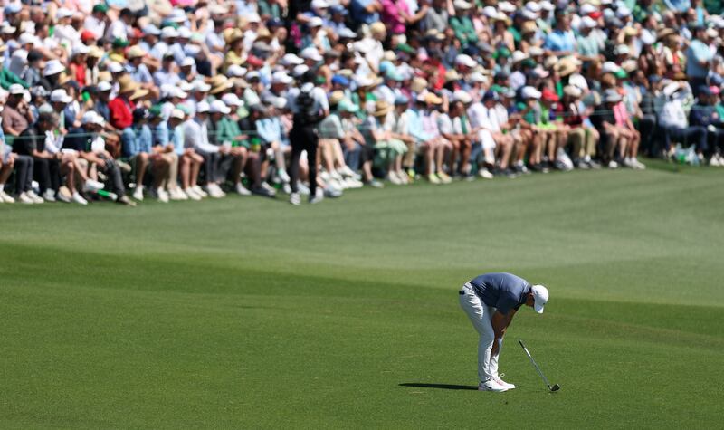 Rory McIlroy drops his club after  his third shot on the second hole. He salvaged a par but Bryson DeChambeau's birdie gave him the lead. Photograph: Richard Heathcote/Getty Images