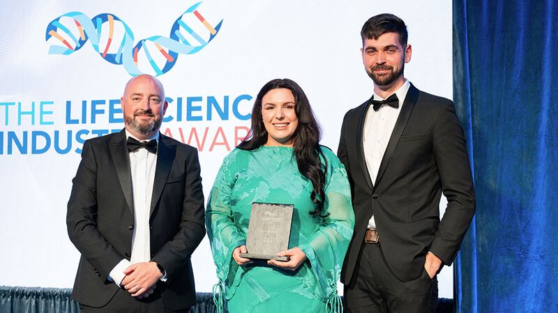 Dave O'Flaherty, director at ACCPRO, presents the best workplace award to Ronan Molumby and Jennifer Kavanagh, Deciphex