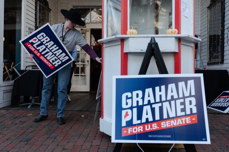 A volunteer sets up signs in support of Graham Platner. Photograph: Sophie Park/Getty Images