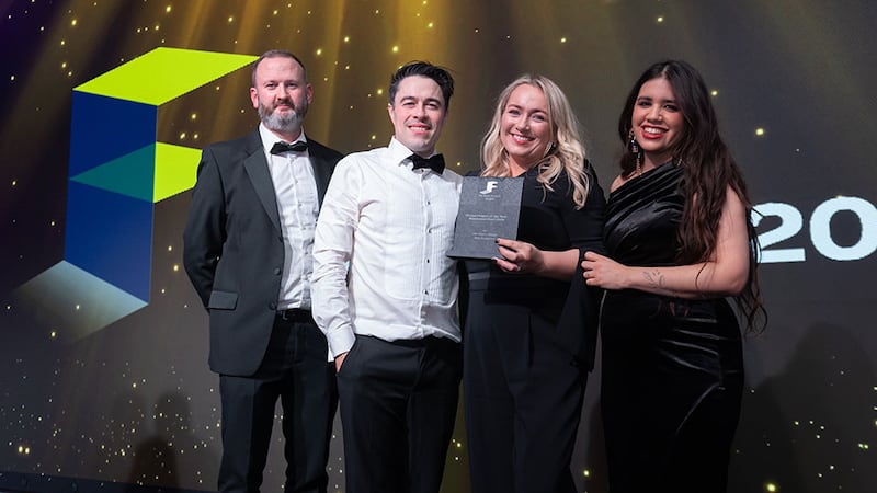 Aidan McGovern, awards judge, presents the fit out project of the year - residential (over €500k) award to Ash Wilson Design team