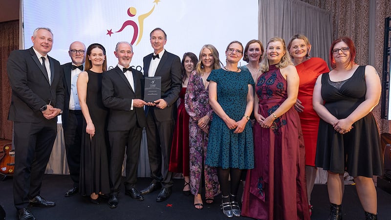 Sean Quigley, awards judge, presents the overall excellence award to the Chartered Accountants Ireland team