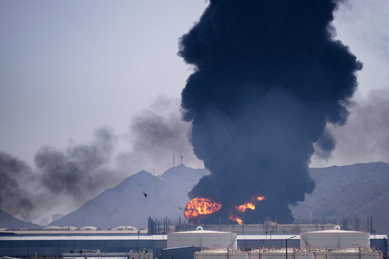 Debris from an intercepted Iranian drone is understood to struck an oil facility in Fujairah, United Arab Emirates, causing a large fire (Altaf Qadri/AP)