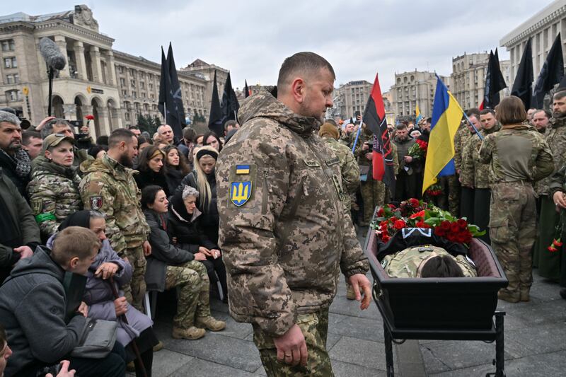 Gen Valery Zaluzhnyi stands next to the open coffin of Dmytro Kotsiubailo, a Ukrainian serviceman killed in combat  in Bakhmut, during a memorial ceremony in Kyiv last March. Photograph: Sergei Supinsky/AFP via Getty Images