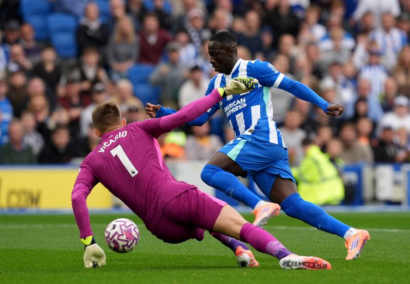 Brightons Yankuba Minteh takes the ball past Tottenham Hotspur goalkeeper Guglielmo Vicario on his way to scoring his side's first goal during the Premier League match at the American Express Stadium. Photograph: Gareth Fuller/PA Wire