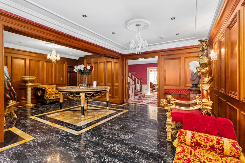 Hall with cherrywood panelling, imported Italian furniture and Nero Marquina black marble inlaid floor