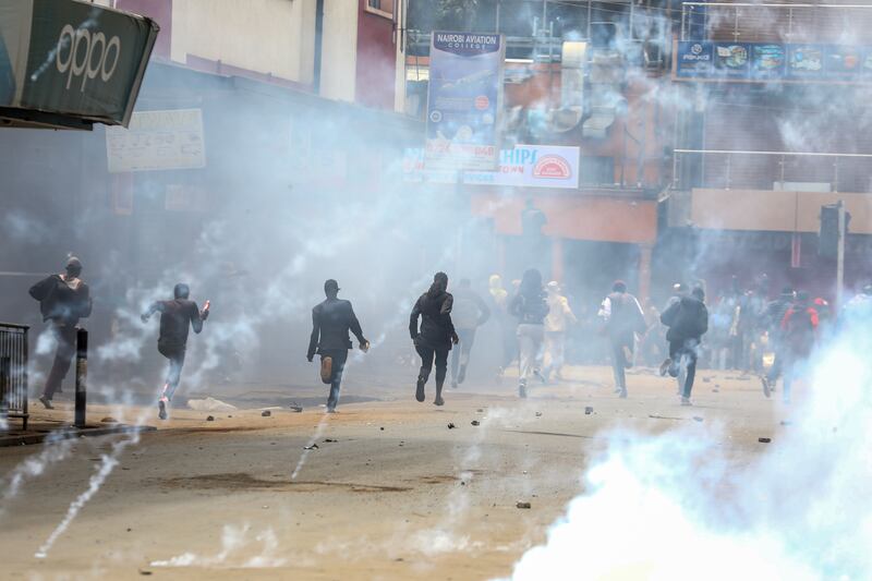 Demonstrators react as police fire tear gas to disperse them in Nairobi on Thursday. Photograph: Daniel Irungu/EPA
