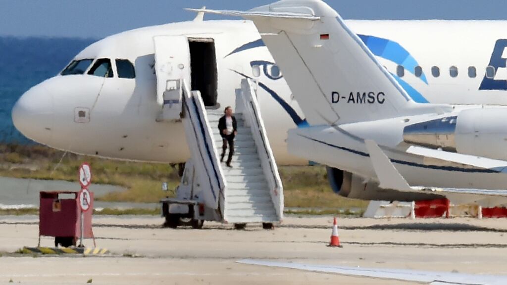 A man believed to be the hijacker of the EgyptAir Airbus 320 leaves the plane before surrendering to security forces after a seven-hour standoff at Larnaca airport, Cyprus. Photograph: AFP/Getty Images