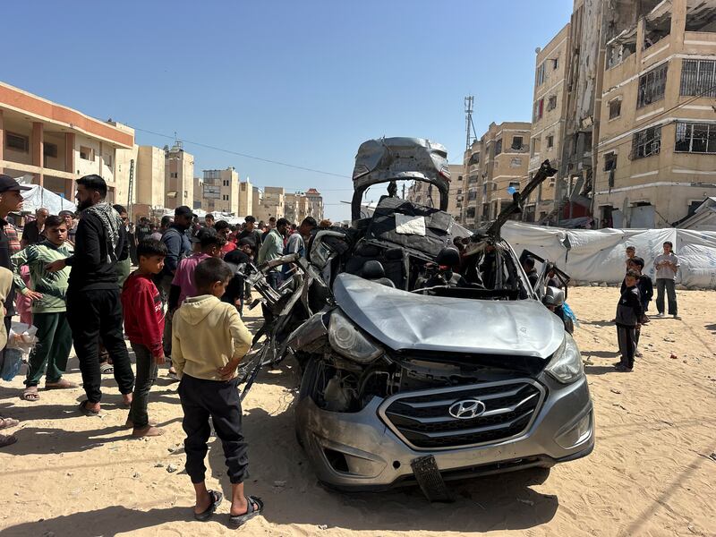 Residents gather around a damaged vehicle following an Israeli strike in the Al-Amal neighbourhood of Khan Younis in the southern Gaza Strip on May 10th. Photograph: Doaa Albaz/Middle East Images/AFP via Getty