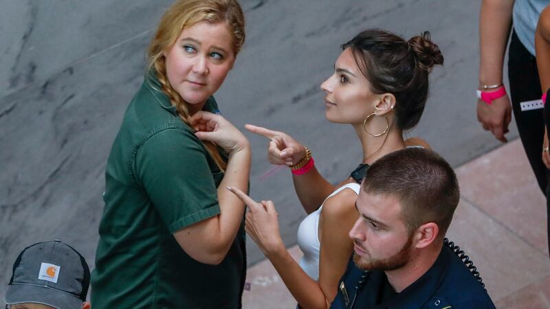 US comedian Amy Schumer (L) and US actress Emily Ratajkowski (R) gesture after getting arrested. Photograph: Erik S. Lesser/EPA