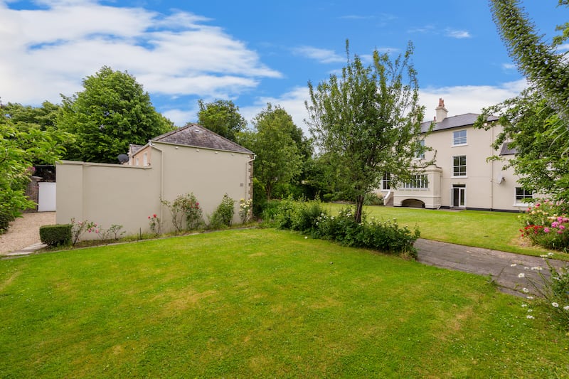 The back garden with the side of coach house visible.