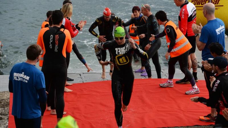 Competitors emerge from the water in Dún Laoghaire during the IronMan 70.3 Dublin triathlon  on Sunday. Photograph: Cyril Byrne/The Irish Times