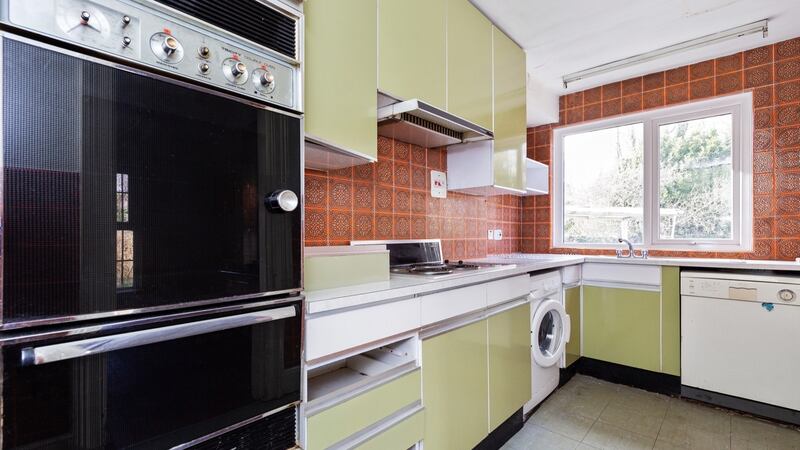 The kitchen with green units that were highly fashionable in the 1970s.