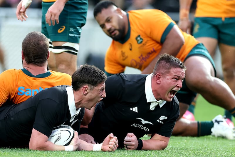 Cam Roigard of the All Blacks celebrates his try  with Ethan de Groot against Australia. Photograph: Phil Walter/Getty
