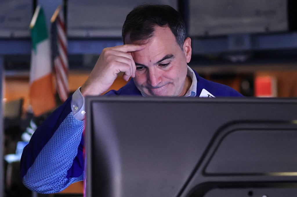 A trader works on the floor of the New York Stock Exchange at the opening bell on Friday. Markets remain volatile and nervous. (Photo by Timothy Clary / AFP)