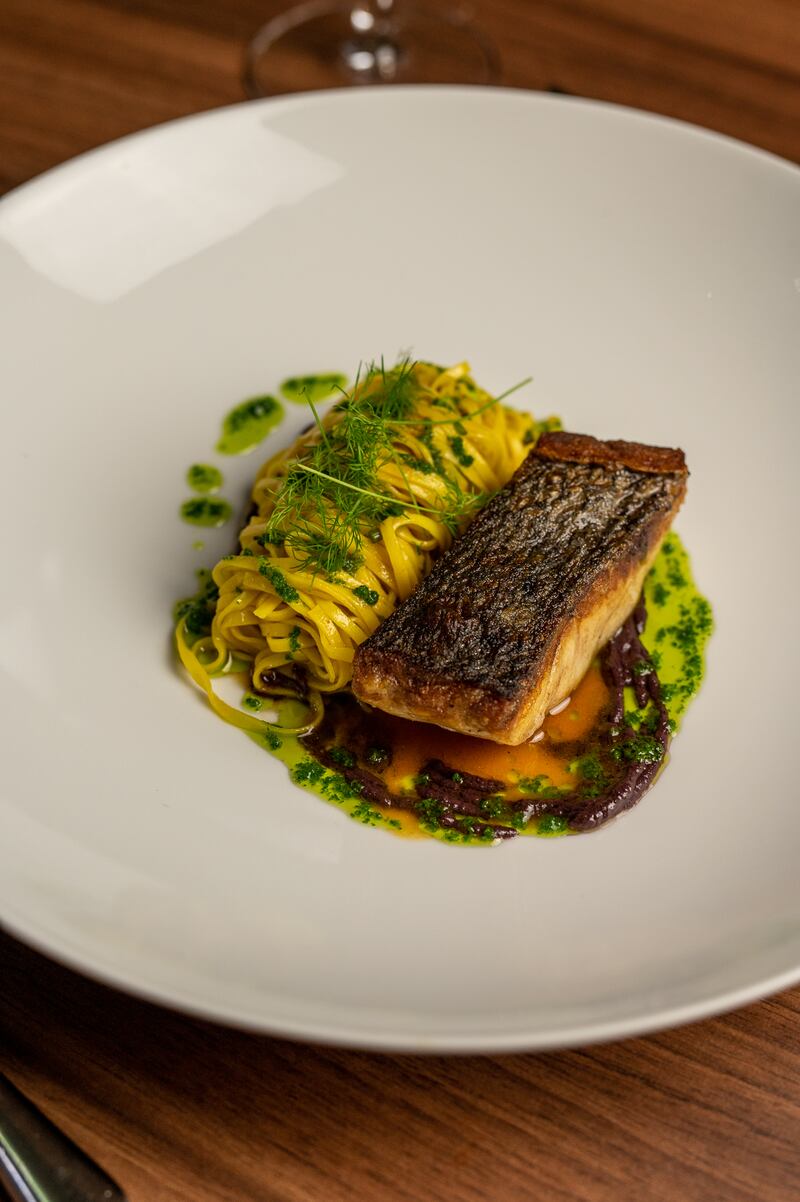 Stone bass with saffron linguine, black olive and bouillabaisse sauce 