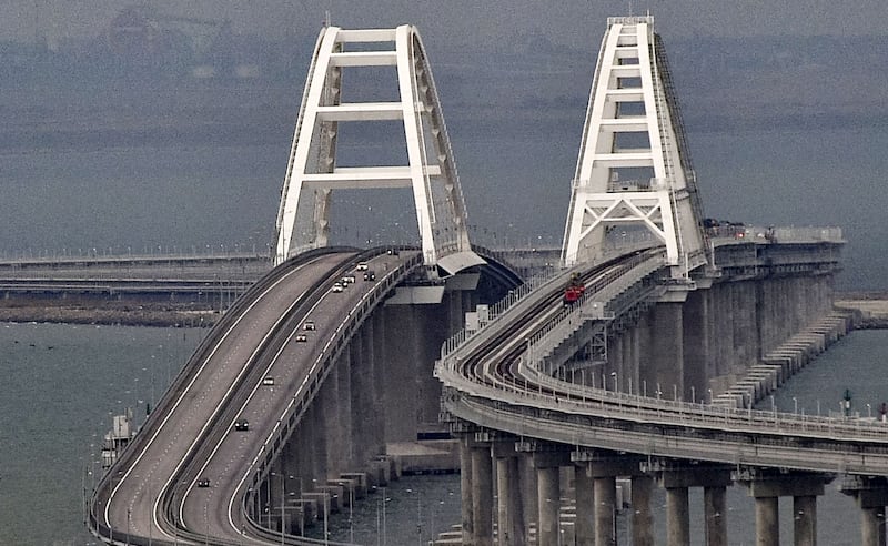 Cars move on the Kerch bridge in Crimea on Sunday after traffic on the undamaged part of the bridge was restored. Photograph: EPA/EFE