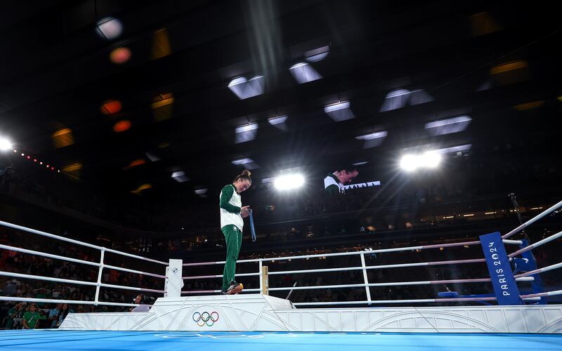 Ireland’s Kellie Harrington celebrates with her gold medal on the podium. Photograph: James Crombie/Inpho