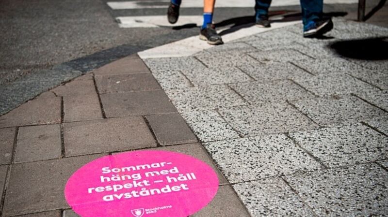 A sticker on the streets of Stockholm translates to: “summer hang out with respect, keep the distance.” Sweden put stock in the sensibility of its people as it largely avoided imposing government prohibitions to halt the spread of Covid-19. File photograph: Getty Images