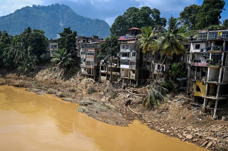 Uprooted trees lie along damaged buildings following a landslide in the aftermath of Cyclone Ditwah in Gampola town, in Kandy district of Sri Lanka on December 4th. Photograph: Ishara S Kodikara/AFP via Getty