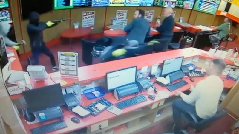 A still image from CCTV footage showing armed raiders entering  Bar One Racing  in Cork on Saturday evening.