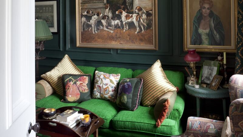 Sittingroom at Shannongrove: moss walls, and and emerald sofa are more than a match for the tartan carpet.