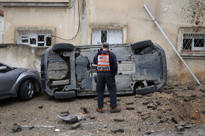 A man surveys the damage to a car following a projectile strike in the Arab-Israeli city of Kfar Qassem on Thursday. Photograph: Ilia Yefimovich/AFP via Getty Images 