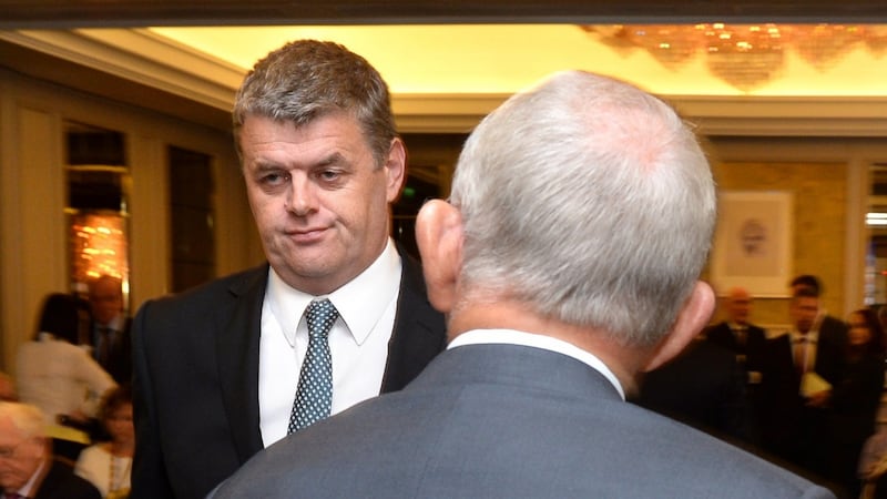 Former chief executive Robert Pitt (left) before walking past then chairman Leslie Buckley at the Independent News & Media AGM in Dublin last August. File photograph: Dara Mac Dónaill/The Irish Times