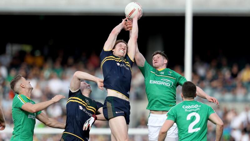Ireland’s Darren Hughes and Ben Brown of Australia contest the ball. Photograph: Tommy Dickson/Inpho