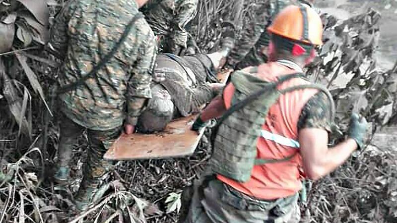 A  handout picture released by the Guatemalan National Army shows army personnel rescue a  victim of the volcano.  Photograph: Getty