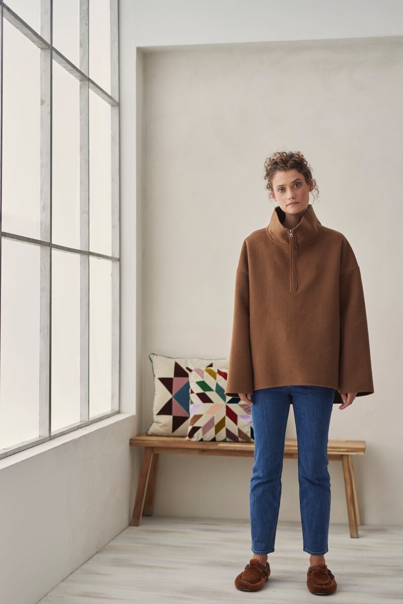 Double-face wool popover half-zip jacket €420, Kingston crop jean €200, both Stylein, velvet cushion €148 by Christina Lundsteen. Photograph: Dylan Madden