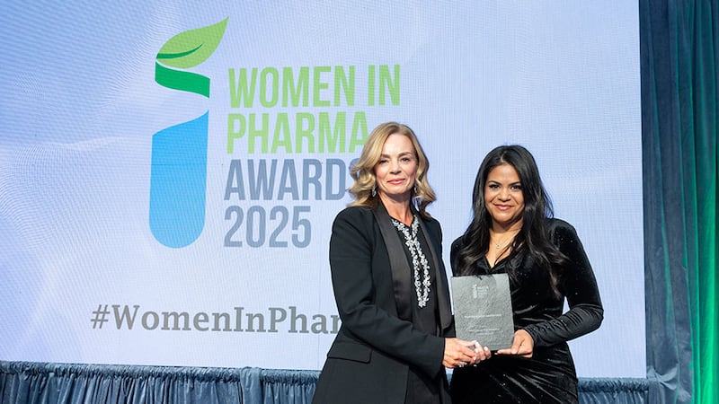 Elizabeth Hunt, senior marketing manager/external communications at Cencora Pharmalex, presents the best education leadership award to Thaís Terêncio on behalf of Loretta Dignam, Menopause Hub Academy