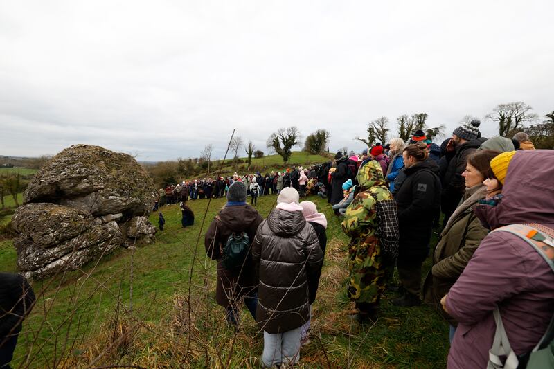 A group gathers at the most famous feature on Uisneach, Ail na Mireann (the stone of divisions), known locally as The Catstone. It is also known as Umbilicus Hiberniae, Axis Mundi, and the navel of Ireland. This huge glacial erratic symbolises Ireland, united in its divisions, and marks the centre of Ireland, where the provinces came together. Photograph: Nick Bradshaw/The Irish Times