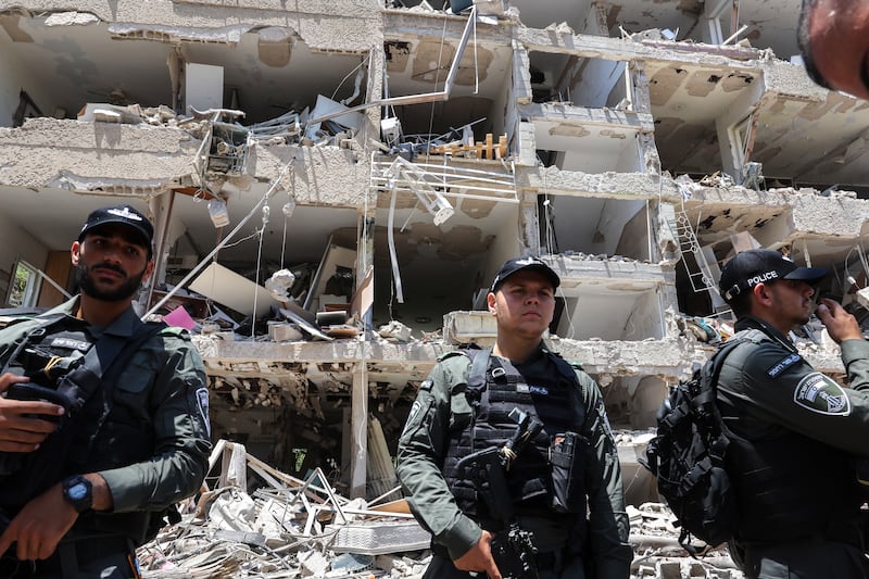 Israeli security forces stand guard at the site of an Iranian strike that hit a residential neighbourhood in the Ramat Aviv area in Tel Aviv overnight.Photo by Jack GUEZ / AFP