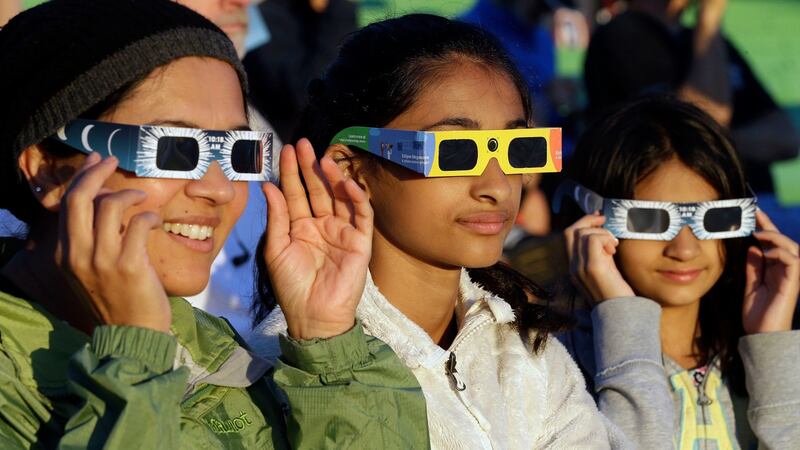 From left, Schweta, Rhea  and Saanvi Kulkarni, from Seattle, try out  eclipse glasses  at  Salem, Oregon, on  Monday, August 21st, 2017. The US was preparing for a total solar eclipse. Photograph: Don Ryan/AP Photo