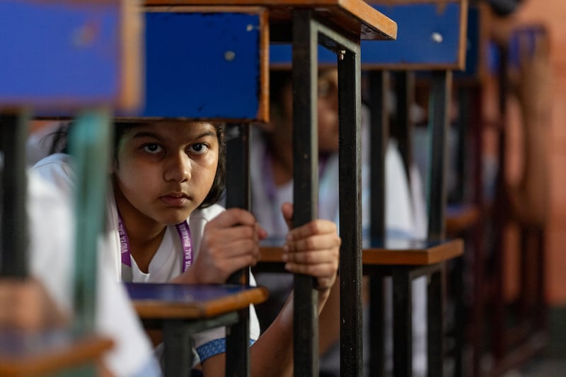 Children take shelter under desks during a civil defence mock drill in New Delhi, India. Photograph: Anindito Mukherjee/Getty Images