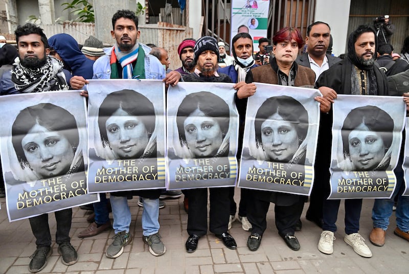 Supporters of Bangladesh's late former prime minister Khaleda Zia hold posters with her portrait as they mourn her death outside the Evercare hospital in Dhaka on December 30th. Photograph: Munir Uz Zaman/AFP via Getty
