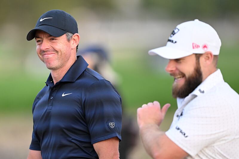 Rory McIlroy of Northern Ireland and Tyrrell Hatton of England smile on the 18th hole. Photograph: Ross Kinnaird/Getty