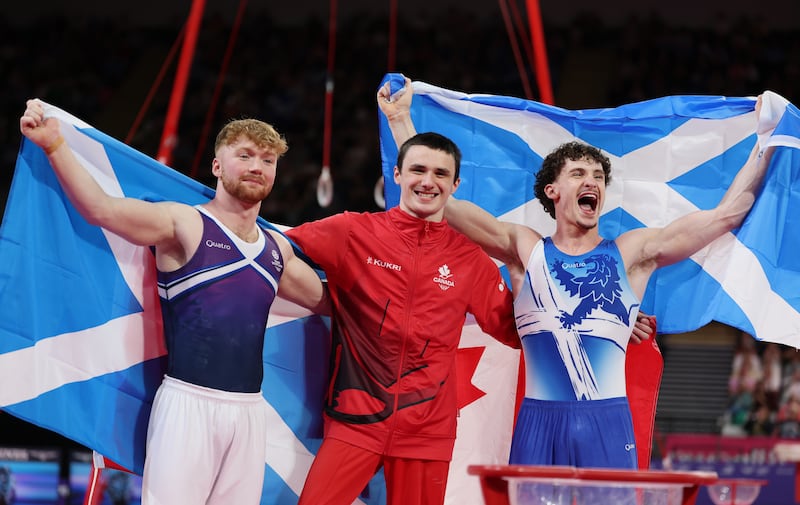 Gold medallist Jordan Carroll of Canada with  silver medallist Reuben Ward of Scotland (right) and bronze medallist Cameron Lynn of Scotland after the men's pommel hose final. Photograph: Lintao Zhang/Getty Images