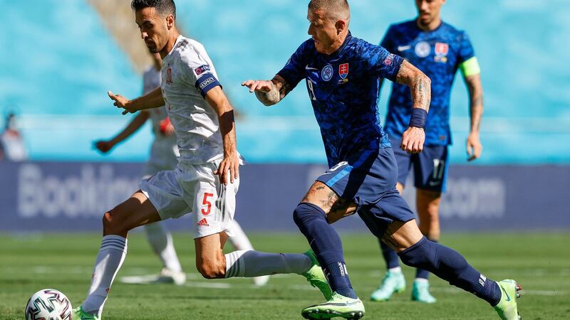 Spain’s Sergio Busquets  is challenged by Slovakia’s  Juraj Kucka during the game at  La Cartuja Stadium in Seville. Photograph: Marcelo del Pozo/AFP via Getty Images