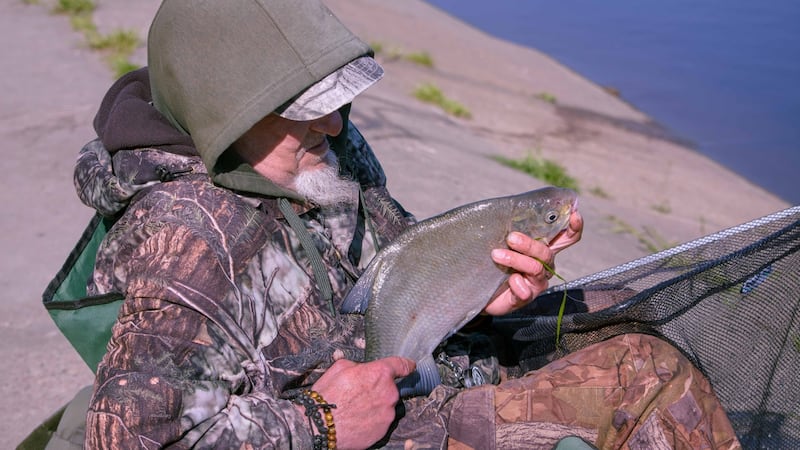 A fisherman displays his catch beside the Nemunas, Lithuania’s longest river