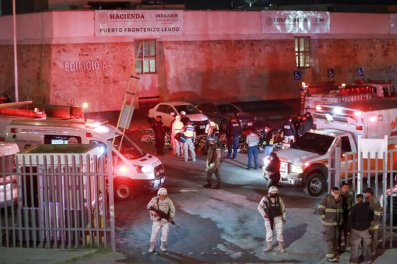 Emergency services attend the scene at the migrant centre in Ciudad Juárez. Photograph: AP