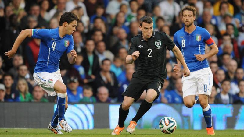 Ireland’s Séamus Coleman (centre) is watched by  Italy’s Mattia De Sciglio (left)   at Craven Cottage. Photograph: Nigel French/PA Wire