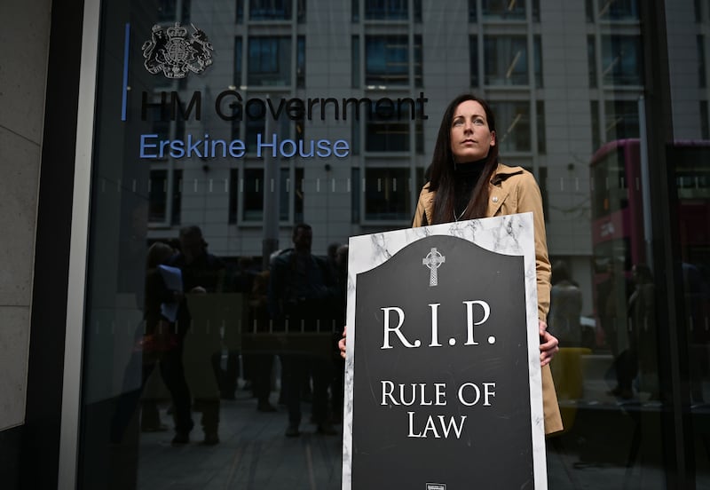 A protester holding a placard as victim's groups and family members who lost loved ones during the Troubles protest outside the Northern Ireland Home Office against the UK government's Legacy Act in May 2024. Photograph: Charles McQuillan/Getty Images